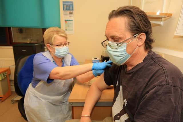 Belgrave Medical Centre reaches vaccine milestone. Pictured is Angus Hunter recieving his vaccine from Janice Wake. Picture: Chris Etchells