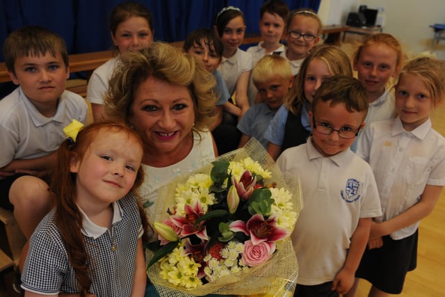 Southwick Primary School headteacher Trish Stoker is pictured with pupils - and the flowers they presented to her - on her retirement in 2016.