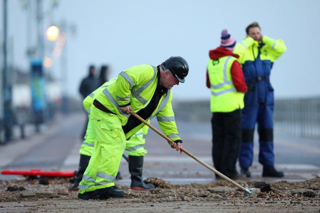 Colas contractors, working on behalf of the city council, clear up on Clarence Esplanade, Southsea, after Storm Barra. Picture: Chris Moorhouse   (jpns 071221-15)