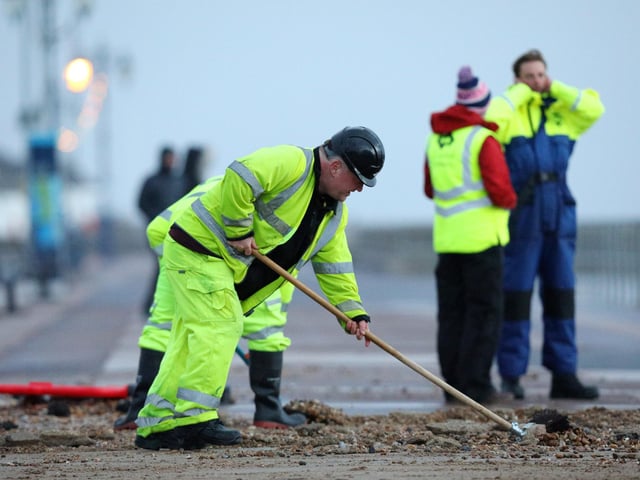 Colas contractors, working on behalf of the city council, clear up on Clarence Esplanade, Southsea, after Storm Barra. Picture: Chris Moorhouse   (jpns 071221-15)