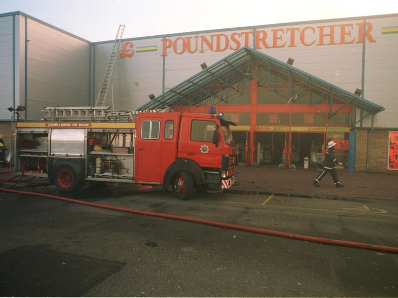 Firefighters try to dampen a fire at the Poundstretcher store at the Fort Kinnaird Retail Park on February 5 1996.