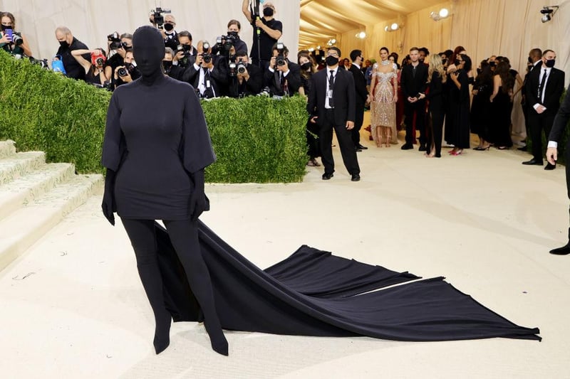 Kim Kardashian hit the runway in a head to toe black bodysuit and train, courtesy of Balenciaga.