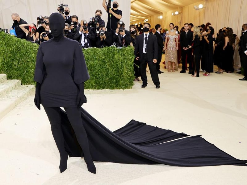 Kim Kardashian hit the runway in a head to toe black bodysuit and train, courtesy of Balenciaga.