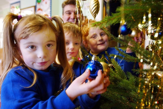 Head teacher Stewart Reader helped pupils put the finishing touches to the Christmas tree in 2003. Can you spot someone you know?