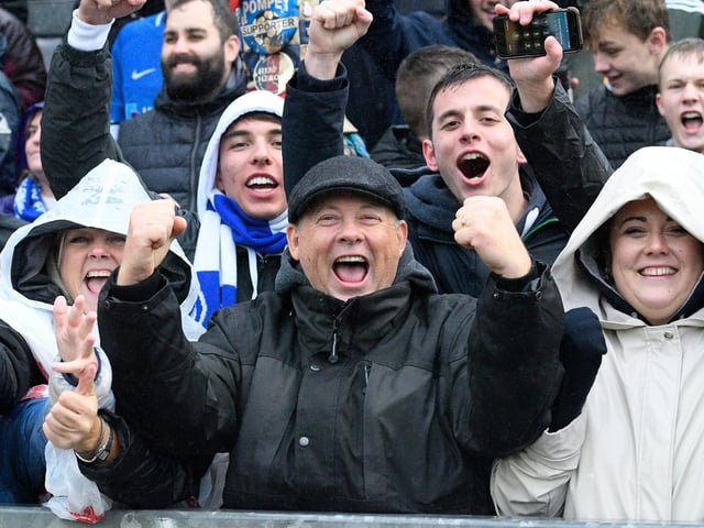 Supporters in the rain at Bristol Rovers