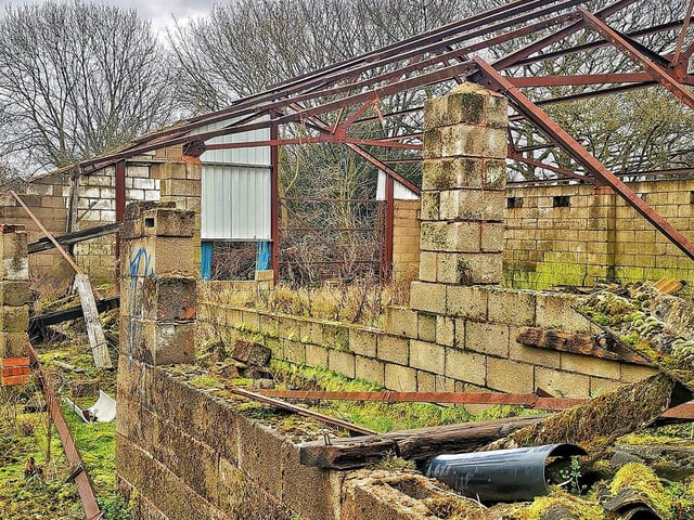 The roof has gone from one outbuilding.