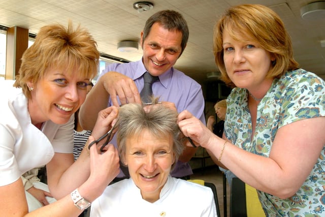 Volunteers  Kirsty Clayton, Darren Moody and Wendy Houghton  prepared to cut  Sue Hodgson's hair in 2006