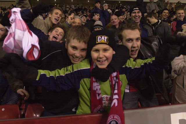 Jubilant United supporters celebrate after watching their side defeat Liverpool in the first leg of the Worthington Cup semi-final at the Lane in January 2003.