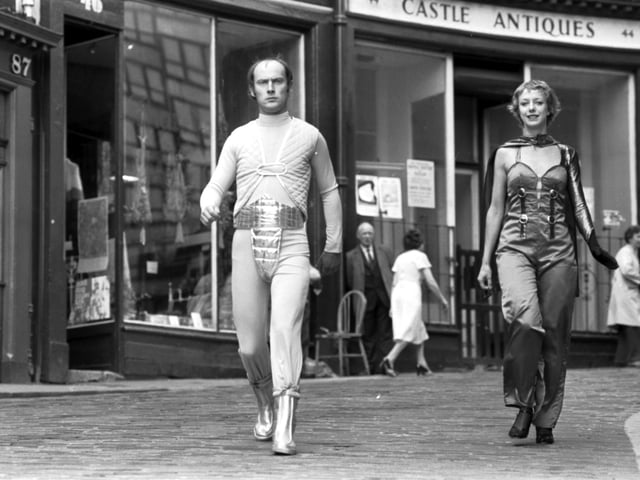 Patrick Malahide and unidentified female take to the Edinburgh streets dressed as robots to promote The Android People at the Traverse theatre during Edinburgh festival Fringe 1978.