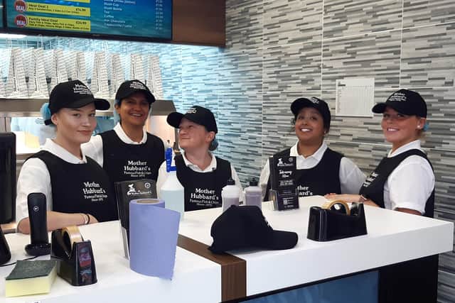 Staff at Sheffield's new Mother Hubbard's fish and chip takeaway and restaurant, on London Road, Sheffield, welcome their first customers during the chippy's opening day with an offer of fish and chips for just 45p.
