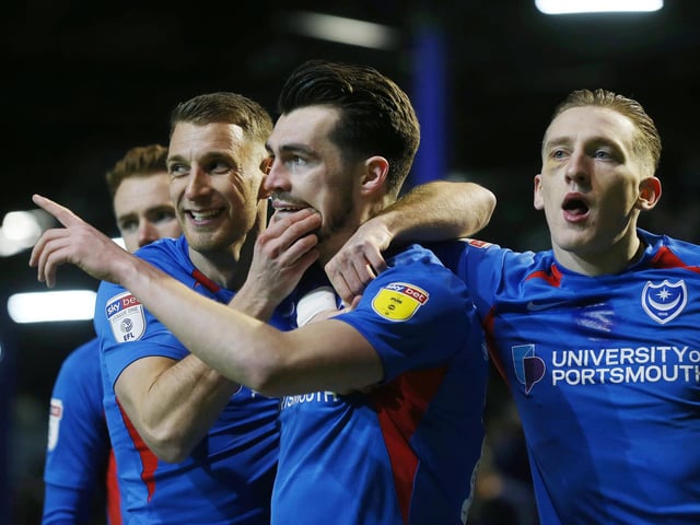 John Marquis is mobbed by his team-mates after putting Pompey 2-1 up
