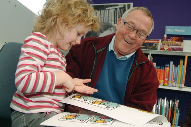 Warsop Grandad Douglas Haywood aged 73 is pictured with his Grandaughter Ellie Haywood aged 5 in the Warsop Childrens Library in  2009