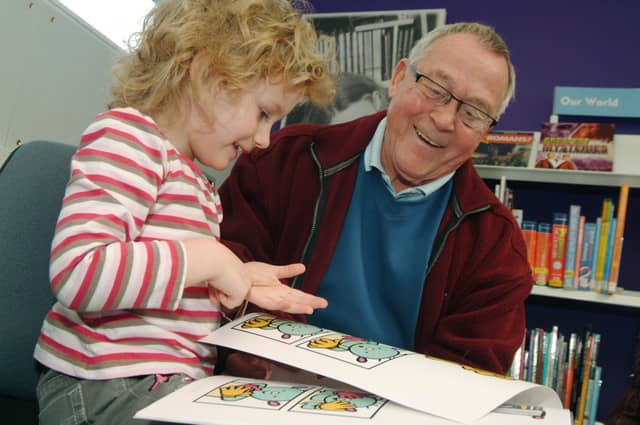 Warsop Grandad Douglas Haywood aged 73 is pictured with his Grandaughter Ellie Haywood aged 5 in the Warsop Childrens Library in 2009