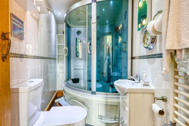 The bathroom contains a luxurious shower, spa, bath unit.