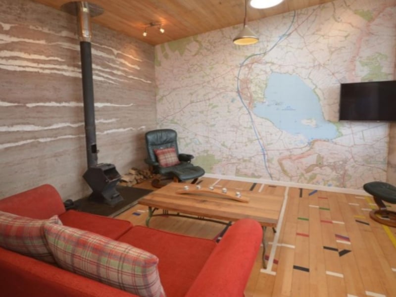 The living room area has comfortable seating and quirky design features.