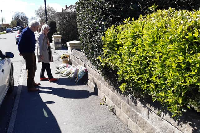 Tributes to Marcia Grant, the well-loved grandmother who died after being struck by a car, have grown along the Sheffield street where she died. Picture shows Cheryl Parrett leaving flowers