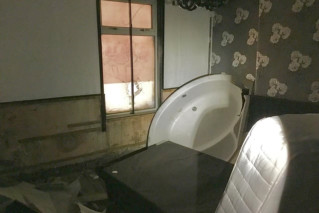 PIcture shows inside one of the rooms at the former City Sauna, including a mattress and a bath tub