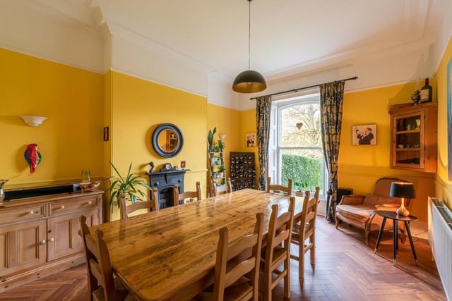The vibrantly-painted dining room offers a large space in which to enjoy family meals.