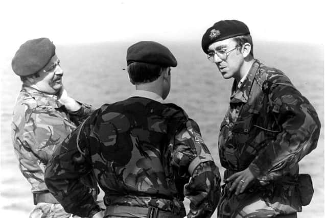 Rev Godfrey Hilliard was chaplain to 40 Commando, the Royal Marines who were among the first troops ashore on the Falkland Islands. He is pictured, right, talking to troops on the Falkland