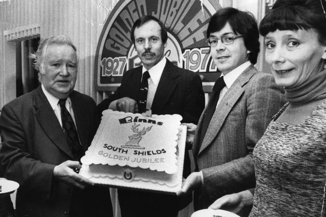 K Price, general manager of Binns, South Shields, cuts the cake to celebrate the firm's 50th anniversary in the town in 1977. Pictured left to right re: E Dennison, G Witten, assistant general manager; and Mrs R Cooper, boutique buyer.