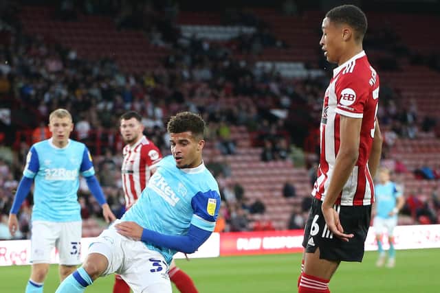 Kornell McDonald of Derby County clears from Daniel Jebbison of Sheffield United: Alistair Langham / Sportimage
