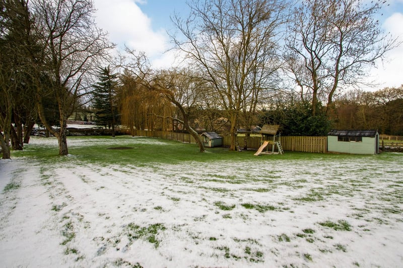 Immediately to the front of the property there is a generous garden which has a variety of mature trees.