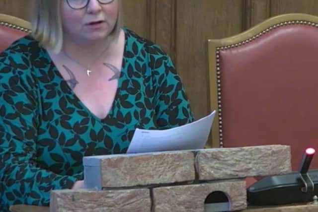 Flora Jeferzade of Sheffield Swift Network presenting the group's petition to the council calling for swift bricks like the one in front of her to be used on all new-build homes in the city