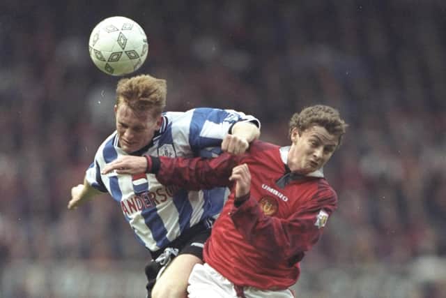 Ole Gunnar Solskaer of Manchester United (right) is out jumped by Mark Pembridge of Sheffield Wednesday during the FA Carling Premiership match at Old Trafford. Mike Hewitt /Allsport
