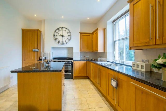 The kitchen has an island, a range oven and French windows in the breakfast area.