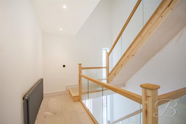 We're heading upstairs now, which means negotiating the landing. It boasts a glass balustrade and gives access to the five bedrooms.