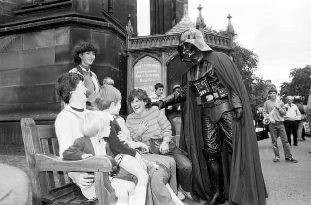 Darth Vader takes a break from the Star Wars promotion at Jenners department store to scare some visitors in Princes Street Gardens, Edinburgh, July 1981.
