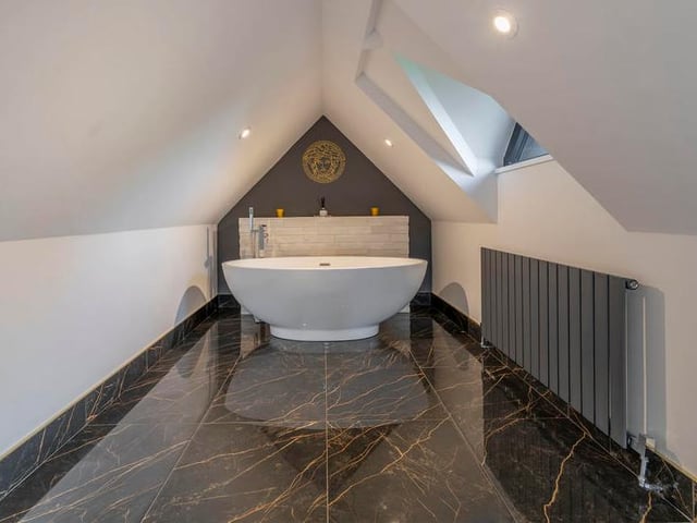 This free-standing bath is a quirky but delightful feature of the second floor. Marvel also at the Italian marble floor.