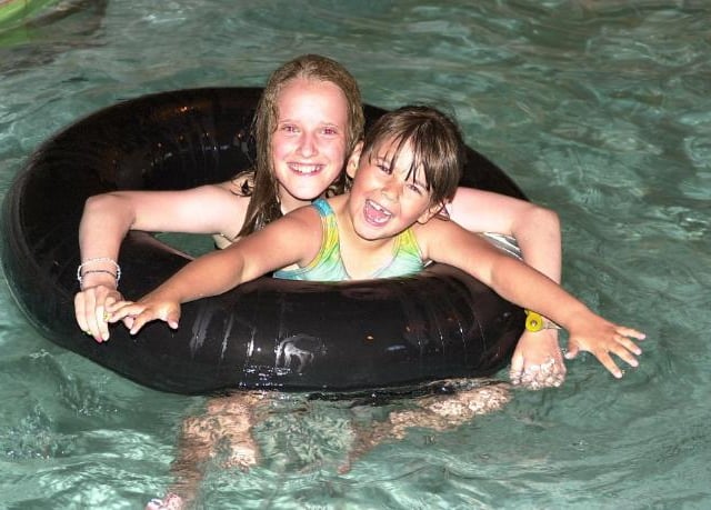 Sisters Stephanie and Nicole Stokes enjoying a swim in 2001.
