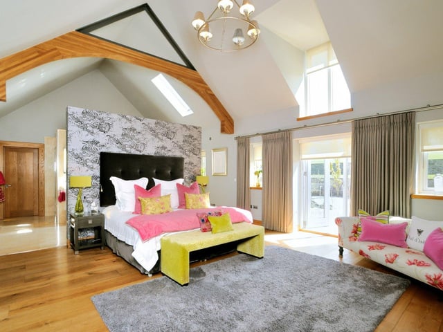 The property boasts four bedrooms in total, with the master benefiting from a luxurious en-suite bathroom, vaulted ceilings and views over the grounds.