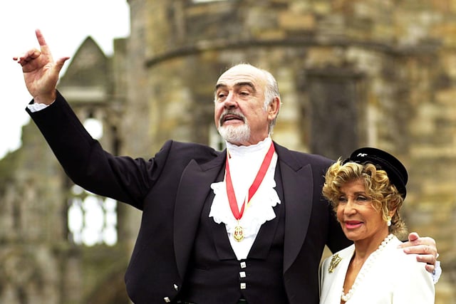 Sir Sean Connery, with wife Micheline, donning full Highland dress and wearing his medal after he was formally knighted by the Queen during a investiture ceremony, at the Palace of Holyroodhouse in Edinburgh.