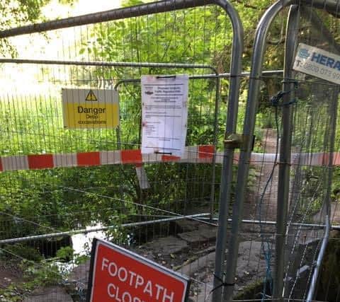 Rivelin Valley Conservation Group say people frustrated at being diverted around the sinkhole which has opened up in Sheffield's Rivelin Valley park are throwing the fencing into the river so they can pass.