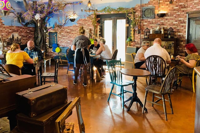 The café area features mismatched furniture to conjure up an antique feel.