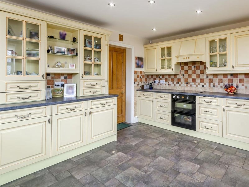 Fitted with a range of integrated appliances, there are dual-aspect windows to the front and the side elevation and access.