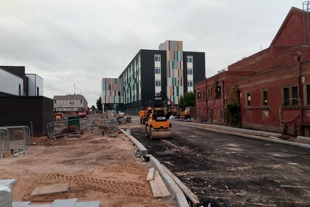 Access road under construction off Waterdale,  with the new University College in the background, and the back of the new cinema site on the left