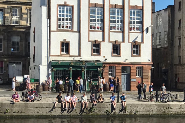 A throng of people enjoy a refreshment outside the Malt & Hope pub on the Shore in Leith. Photo: Brian Ferguson