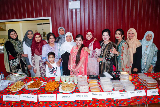 The Rainbow Ladies who run the Rainbow Muslim Women's Group proudly display their cooking.