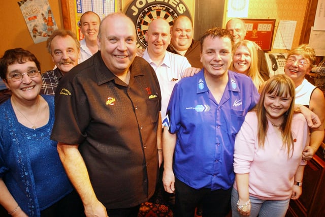 Darts stars Cliff Lazarenko and Keith Deller are pictured with members of the Jollies pub darts teams in 2005.
