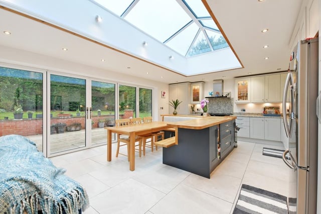 The striking dining/kitchen has fitted units with integrated appliances. Impressive roof lantern, bi folding doors and separate French doors which open onto the stunning gardens.