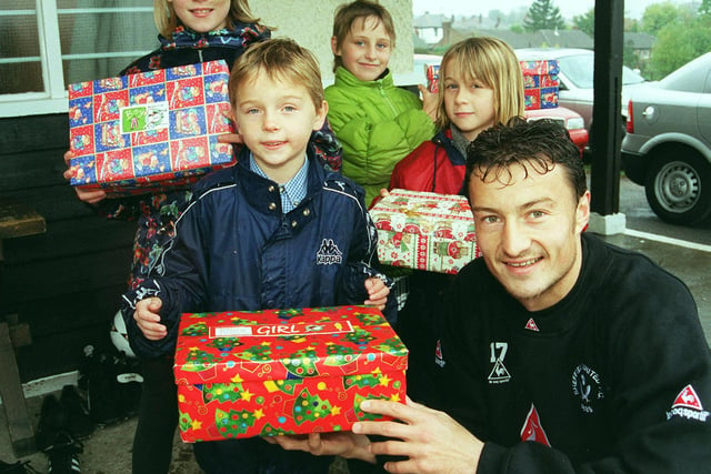 Pictured at the Sheffield United Training ground in 1999, where United player Petr Katchouro took time out to help launch the Samaritans annual Christmas shoebox appeal to help needy youngsters in Eastern European contries. Seen is Petr with children from Dobcroft Junior school who are taking part in the appeal. LtoR are, Sarah Bailey, William Jackson, Sonia Bailey, and Elin  Davies