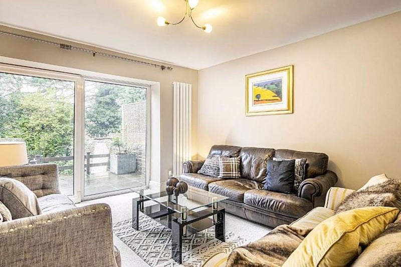 The living room has designer space-saving radiators and patio doors to a private terrace.