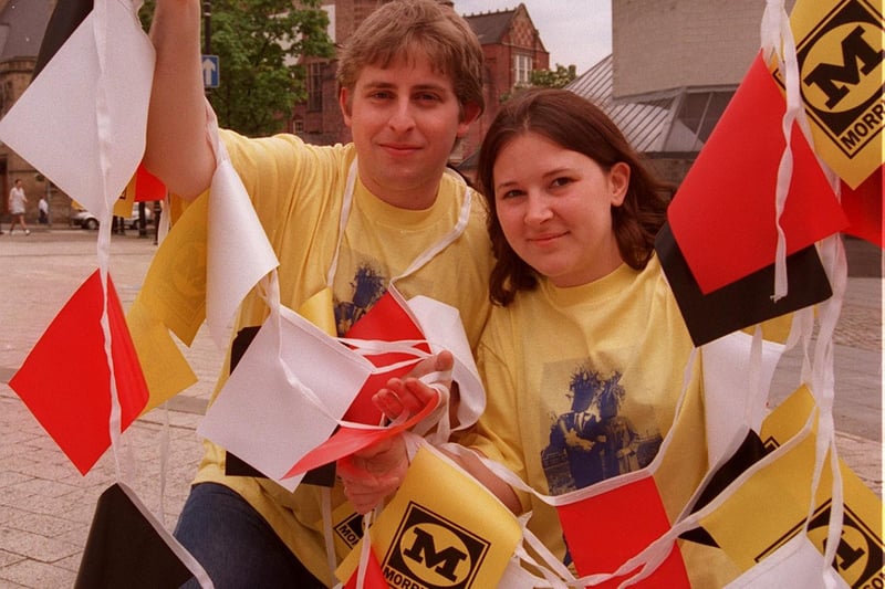 Volunteers Simon Cookson (22) and Amanda Fryer (26) put up bunting in Tudor Square for the Sheffield Plays at Home festival during the Euros