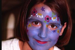 India Thompson, aged 11. Flowers painted on her face with a blue backgrop in 1996.