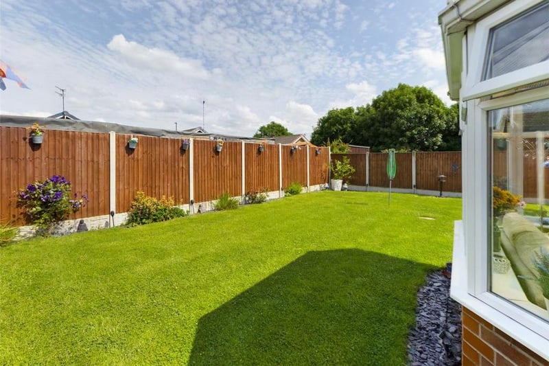 Rear garden - Fence enclosed, laid to lawn with raised flower beds, paved path and patio area. External lighting and garden tap.