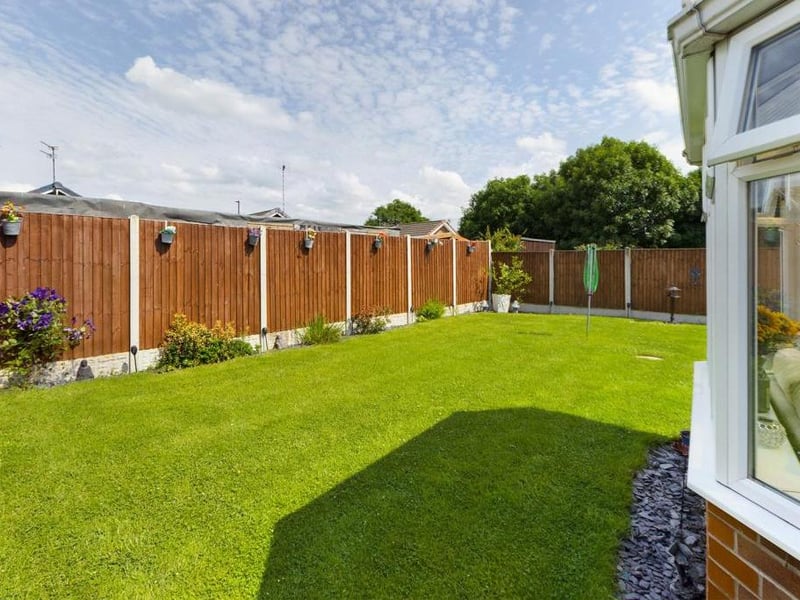 Rear garden - Fence enclosed, laid to lawn with raised flower beds, paved path and patio area. External lighting and garden tap.