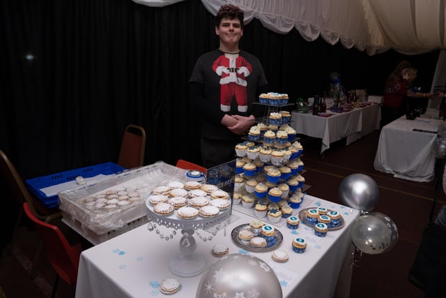 A volunteer from Worksop Post 16 Centre helps to sell buns to raise money for Retina UK.